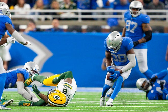 Jan 9, 2022; Detroit, Michigan, USA; Detroit Lions defensive back C.J. Moore (38) makes an interception off a deflection from Green Bay Packers wide receiver Amari Rodgers (8) during the fourth quarter at Ford Field. Mandatory Credit: Raj Mehta-USA TODAY Sports