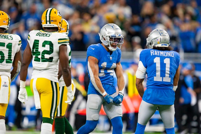 Jan 9, 2022; Detroit, Michigan, USA; Detroit Lions wide receiver Amon-Ra St. Brown (14) celebrates with wide receiver Kalif Raymond (11) after a play during the fourth quarter against the Green Bay Packers at Ford Field. Mandatory Credit: Raj Mehta-USA TODAY Sports