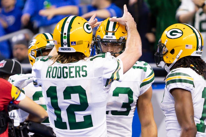 Jan 9, 2022; Detroit, Michigan, USA; Green Bay Packers quarterback Aaron Rodgers (12) celebrates with wide receiver Allen Lazard (13) after the pair connect for a touchdown during the first quarter against the Detroit Lions at Ford Field.