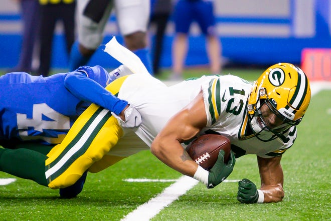 Jan 9, 2022; Detroit, Michigan, USA; Green Bay Packers wide receiver Allen Lazard (13) gets tackled by Detroit Lions cornerback AJ Parker (41) during the first quarter at Ford Field.