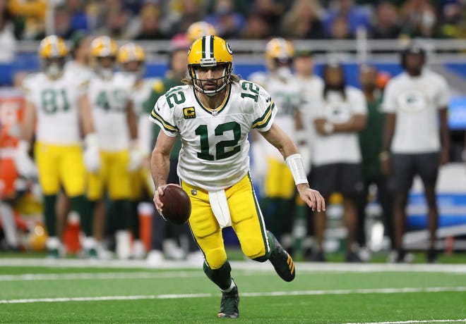 DETROIT, MICHIGAN - JANUARY 09: Aaron Rodgers of the Green Bay Packers scrambles with the ball against the Detroit Lions during the first quarter at Ford Field on January 09, 2022 in Detroit, Michigan.