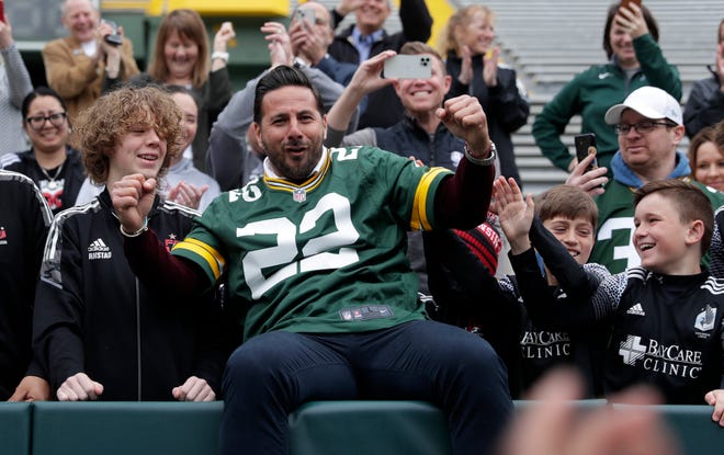 Former FC Bayern Munich player Claudio Pizarro wears a Green Bay Packers jersey and learns how to do the Lambeau Leap after the announcement was made May 2, 2022, that Bayern will play Manchester City this summer in the first soccer match ever held at Lambeau Field.
