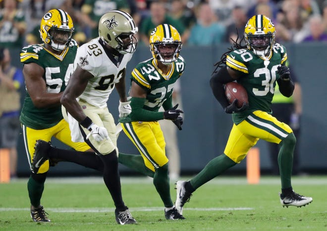 Green Bay Packers safety Shawn Davis (30) runs back his fumble recovery against the New Orleans Saints during the game Friday, Aug. 19, 2022, at Lambeau Field in Green Bay, Wis.