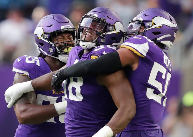 Minnesota Vikings linebacker Za'Darius Smith, left, and linebacker Jordan Hicks, right, celebrate with D.J. Wonnum after he sacked Green Bay Packers quarterback Aaron Rodgers in the fourth quarter during their football game Sunday, September 11, 2022, at U.S. Bank Stadium in Minneapolis, Min. 
Dan Powers/USA TODAY NETWORK-Wisconsin