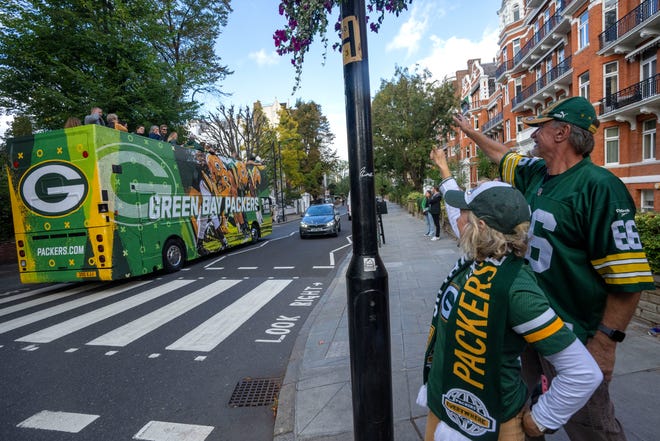 Denise and Don Larenz wave Green Bay Packers-themed double decker bus caring fans at the Abbey Road crosswalk made famous by the Beatles Friday, October 7, 2022 in London. The couple is from Waukesha. The Packers will play their first game ever in the United Kingdom on Sunday against the New York Giants.