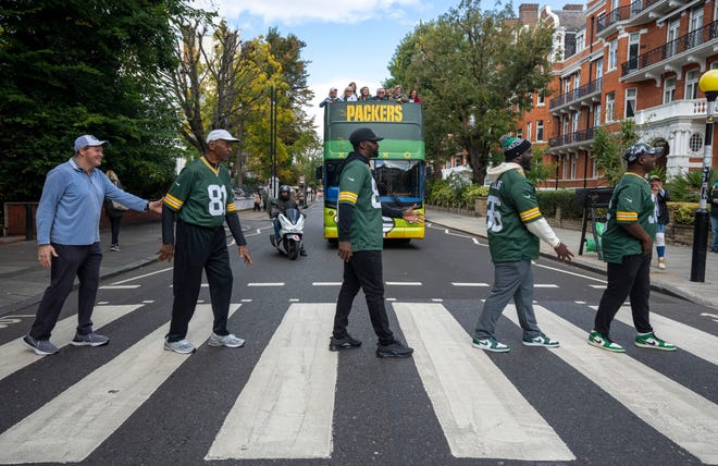 Green Bay Packers president Mark Murphy, left, along with former players Marv Fleming, James Jones, Nick Collins and LeRoy Butler transit the Abbey Road crosswalk made famous by the Beatles during a tour Friday, October 7, 2022 in London. The Packers will play their first game ever in the United Kingdom on Sunday against the New York Giants.
