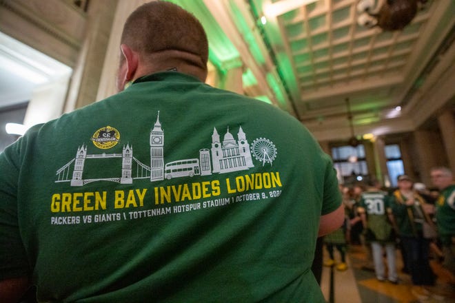A fan sports a commemorative t-shrt during a rally put on by Ashwaubenon-based Event USA Friday, October 7, 2022 in London. The Packers will play their first game ever in the United Kingdom on Sunday against the New York Giants. About 750 people attend the event. The company was formerly known as Packer Fan Tours.