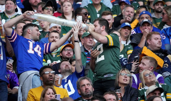 Oct 9, 2022; Tottenham,  ENG;  Fans drink during the second quarter of the Green Bay Packers game against the New York Giants at Tottenham Hotspur Stadium.