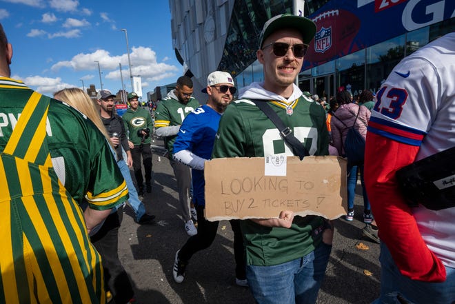 A fan advertises for tickets to attend the Green Bay Packers game against the New York Giants Sunday, October 9, 2022 outside Tottenham Hotspur Stadium in London. The Green Bay Packers will play their first game ever in the United Kingdom on Sunday against the New York Giants.