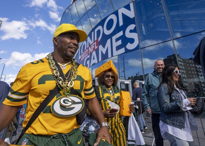 Sporting a Cheesehead to cheer on her son, Green Bay Packers running back Aaron Jones, Vurgess Jones walks around with family friend Don Walton before the Green Bay Packers game against the New York Giants Sunday, October 9, 2022 outside Tottenham Hotspur Stadium in London. The Green Bay Packers will play their first game ever in the United Kingdom on Sunday against the New York Giants. They are from El Paso, Texas.
