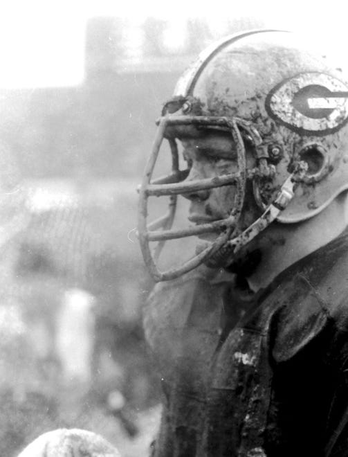 Green Bay Packers center Ken Bowman (57) stands covered in mud during a 13-0 victory over the San Francisco 49ers on Nov. 19, 1967, at Lambeau Field in Green Bay, Wis.