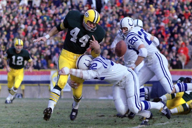 The ball is knocked out of the hands of Green Bay Packers running back Donny Anderson (44) by linebacker Mike Curtis (32) on Dec. 7, 1968, at Lambeau Field in Green Bay, Wis. The Baltimore (now Indianapolis) Colts defeated the Packers 16-3.