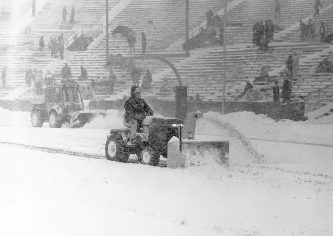 Grounds crew plows snow off the field on Dec. 1, 1985, during the Snow Bowl at Lambeau Field in Green Bay, Wis.