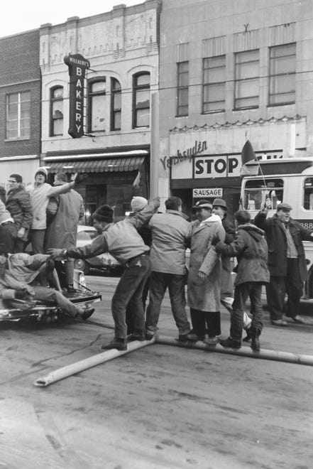 Fans celebrate with a part of the goal post on Adams Street in downtown Green Bay after the Green Bay Packers defeated the New York Giants 37-0 in the NFL World Championship on Dec. 31, 1961, in New City Stadium (Lambeau Field) in Green Bay, Wis.