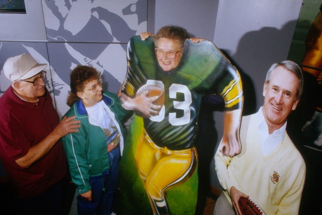 Green Bay Packer fans Charles and Joan Hanson and daughter Julie (behind cutout) of Bayport, Minnesota, visit the Packer Hall of Fame on Sept. 14, 1991, in Green Bay, Wis.