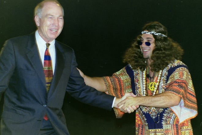 Former Green Bay Packers quarterback Bart Starr, left, shakes the hand of a man dressed as a hippy during the unveiling of Green Bay Packers stamps on Sept. 17, 1999, at ShopKo Hall in Ashwaubenon, Wis. The U.S. Postal Service produced 15 stamps to commemorate the 1960s.