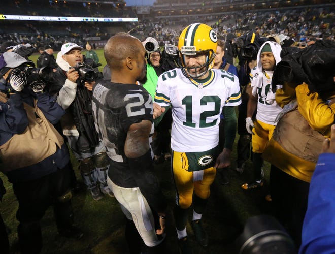 PACKERS21 - Green Bay Packers quarterback Aaron Rodgers (12) and Oakland Raiders free safety Charles Woodson (24) greet each other after the Green Bay Packers 30-20 win over the Oakland Raiders game Sunday, December 20, 2015 at in O.co Coliseum in Oakland, Calif.