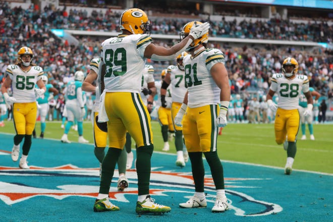 Marcedes Lewis (89) of the Green Bay Packers celebrates with Josiah Deguara (81) after a touchdown during the first quarter of the game against the Miami Dolphins at Hard Rock Stadium on Dec. 25, 2022, in Miami Gardens, Florida.
