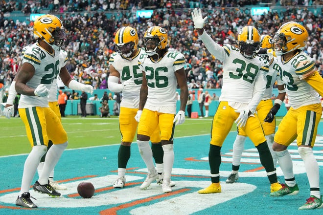 Members of the Green Bay Packers celebrate after an interception in the fourth quarter of the game against the Miami Dolphins at Hard Rock Stadium on Dec. 25, 2022, in Miami Gardens, Florida.